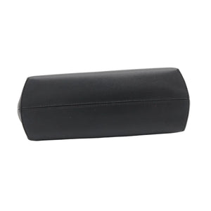 A black leather clutch bag with a smooth texture, photographed from a side angle on a clean white background.