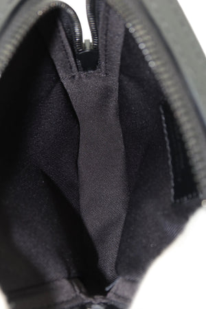 Close-up of the interior of a black zippered pouch or small bag, showing a dark fabric lining and zipper track against a white background.