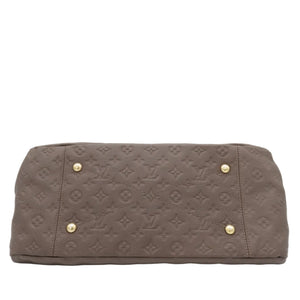 A Louis Vuitton monogram canvas shoulder bag in taupe brown, featuring gold-tone metal studs on the front, photographed against a light gray background.