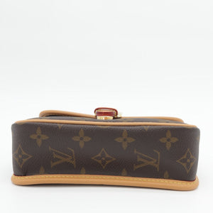 A Louis Vuitton monogram canvas clutch bag shown from a top-down view against a plain white background.
