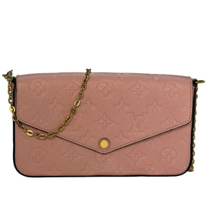 A pink Louis Vuitton monogram envelope shoulder bag with a gold-tone chain strap and snap closure, displayed on a reflective white surface against a gray background.