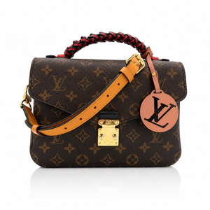 
Louis Vuitton Pochette Métis Crossbody Bag with Braided  leather strap, gold-tone hardware, and a round tan leather LV logo charm on a white background.