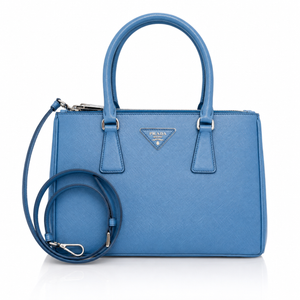 Prada Galleria Medium Saffiano Leather Bag – Blue dual top handles, a zip-top closure, and a matching blue shoulder strap coiled in front, set against a clean white background.
