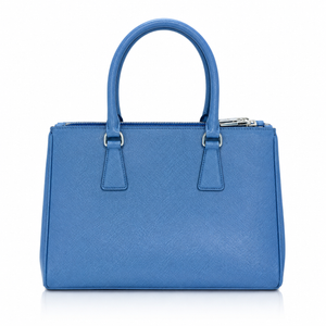 Prada Galleria Medium Saffiano Leather Medium blue textured leather handbag with double top handles, a top zipper closure, and silver-tone hardware, shown against a plain white background.
