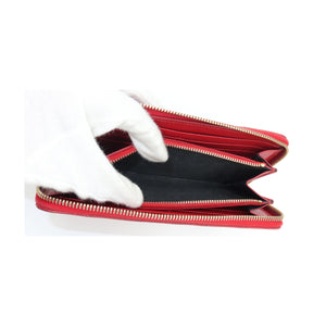 Saint Laurent YSL Red Chevron Grain de Poudre Zip Around Wallet Gold Logo zip-around wallet with gold-tone zippers and a black interior, shown open with a white gloved hand holding it against a white background
