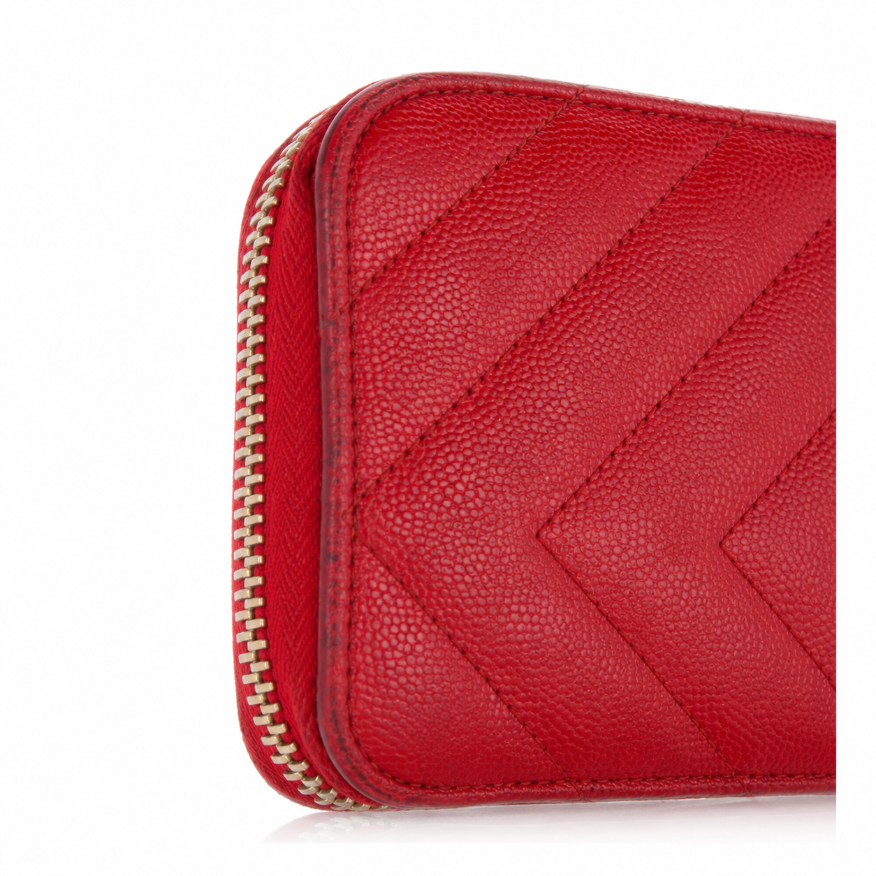 Saint Laurent YSL Red Chevron Grain de Poudre Zip Around Wallet Gold Logo A close-up of a red pebbled leather zip-around wallet with a chevron quilted pattern and a gold-tone zipper.