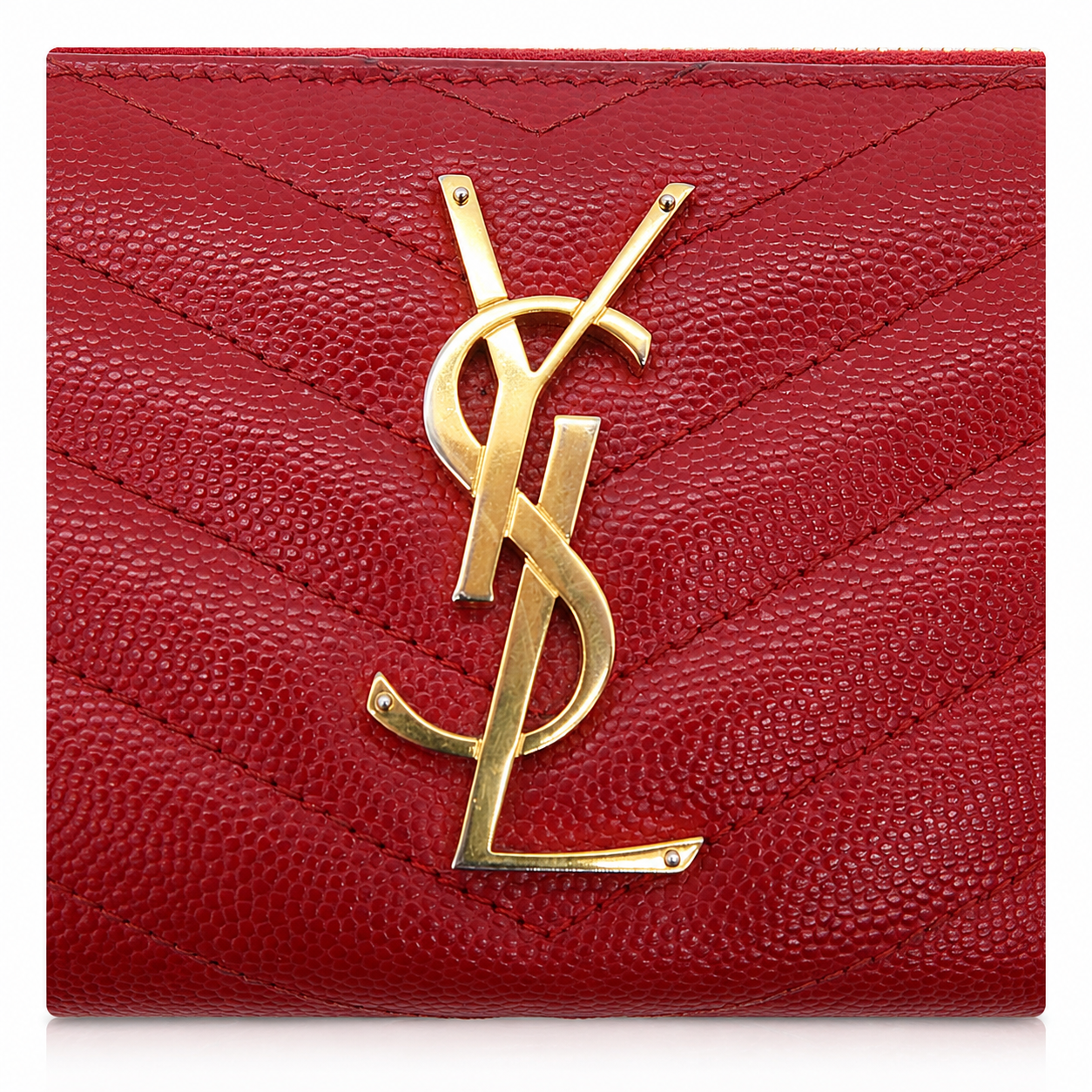 A close-up of a red pebbled leather wallet or card case with a large gold-tone interlocking YSL logo on the front, set against a plain white background.