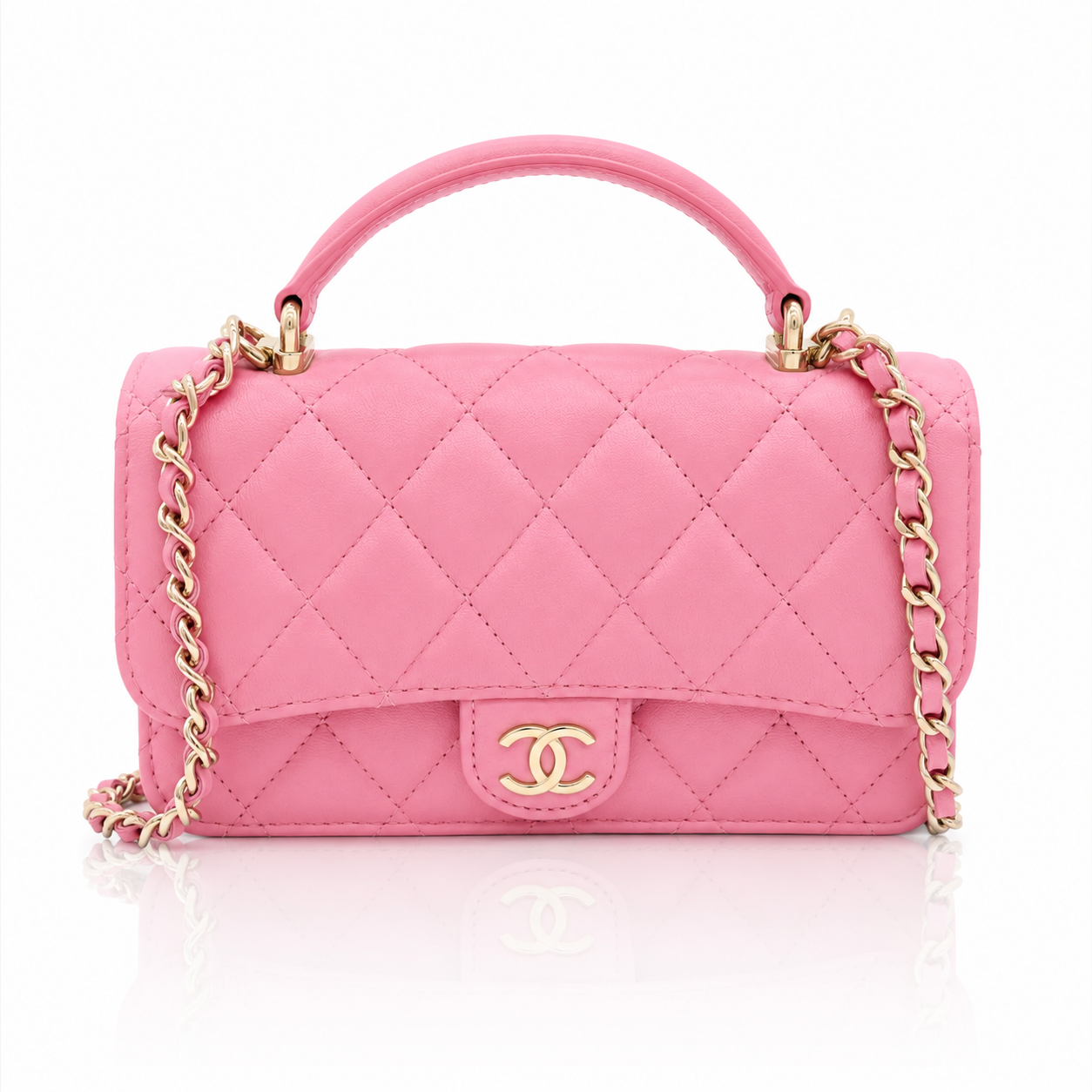 chanel-mini-top-handle-pink-lambskin-front-view gold-tone chain strap, and a gold interlocking CC logo on the front, photographed on a clean white background.