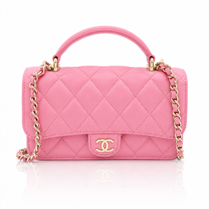 chanel-mini-top-handle-pink-lambskin-front-view gold-tone chain strap, and a gold interlocking CC logo on the front, photographed on a clean white background.