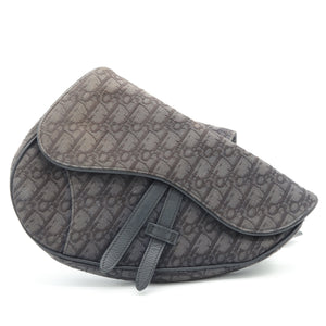 A dark gray Dior saddle bag featuring the brand's signature monogram pattern, shown on a plain white background.