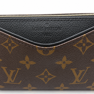 Close-up of a Louis Vuitton monogram pouch or clutch showing the brown coated canvas with gold-tone LV monogram pattern and a black leather trim along the top zipper.