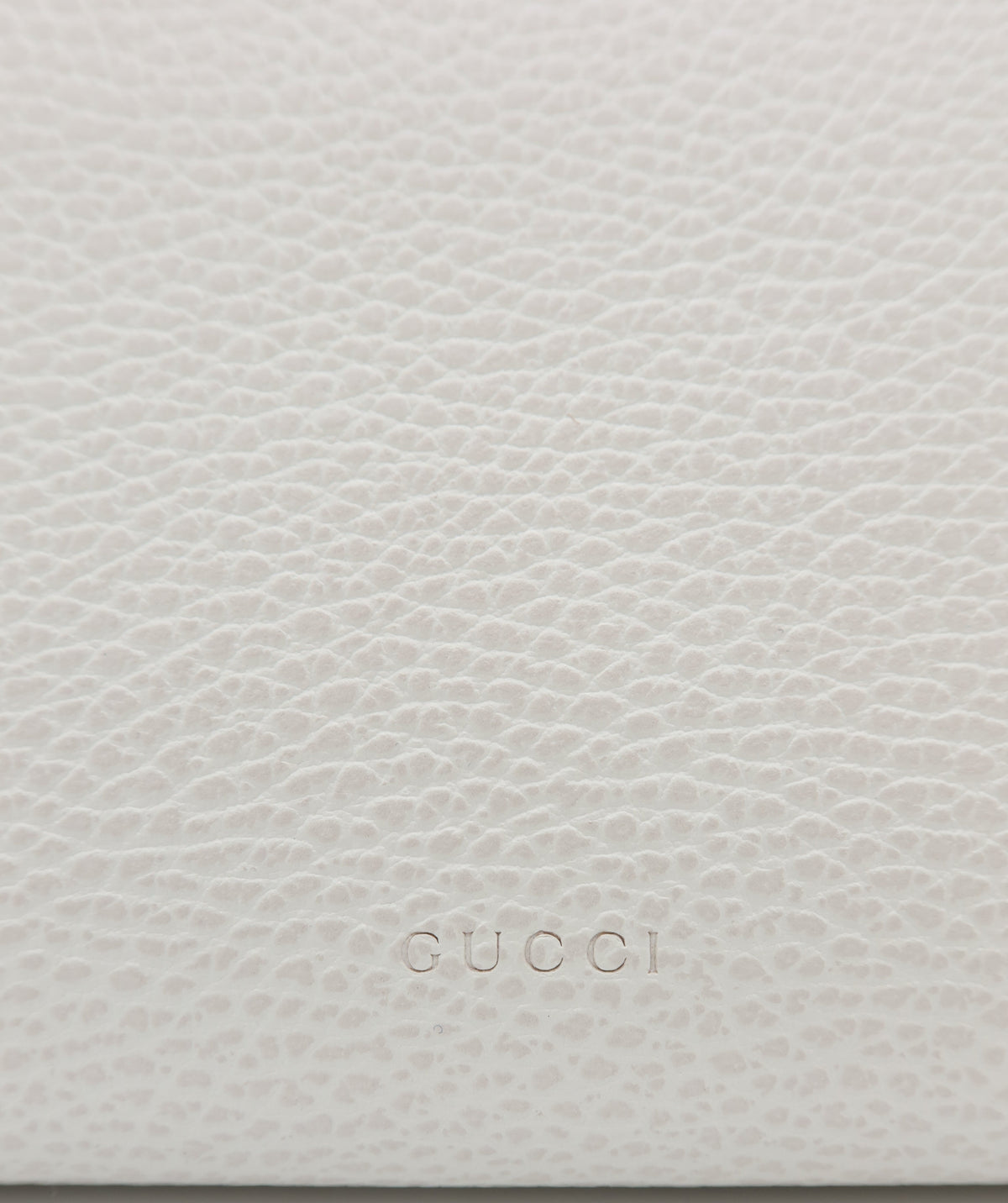 Gucci Dionysus Cream Leather Mini Chain Shoulder Bag – Close-up of a light beige pebbled leather surface with the embossed