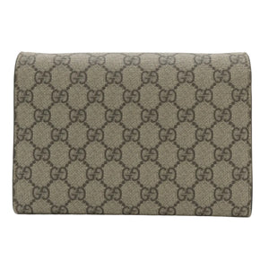A Gucci monogram canvas wallet in beige and brown, shown closed against a plain light gray background.