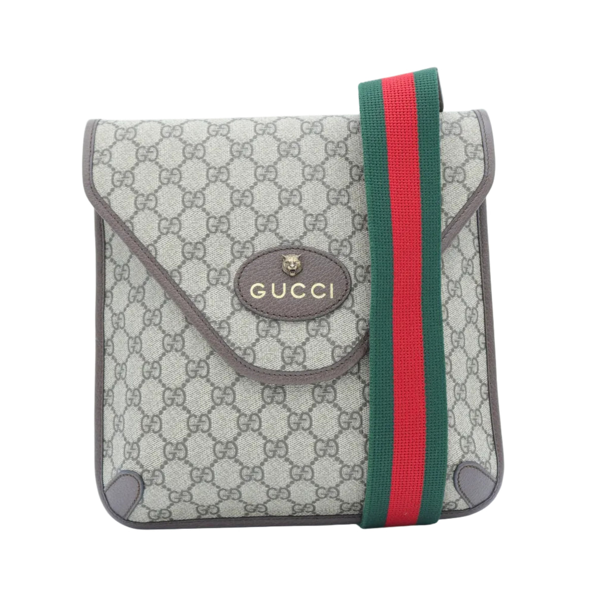 A small Gucci flap bag in beige GG Supreme canvas with brown leather trim and a green and red web stripe detail, shown on a plain white background.