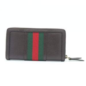 A dark brown leather zip-around wallet featuring the signature green and red web stripe across the front, shown on a plain white background.