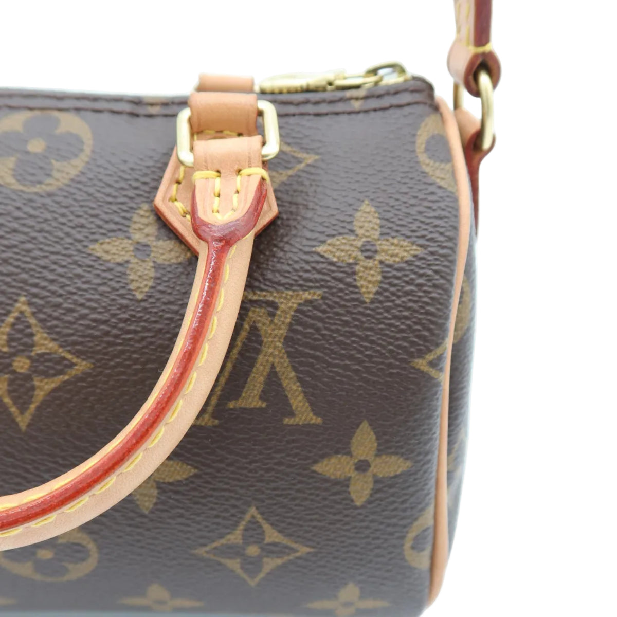 Close-up of a Louis Vuitton monogram handbag in brown coated canvas with tan leather trim and gold-tone hardware, shown against a white background.