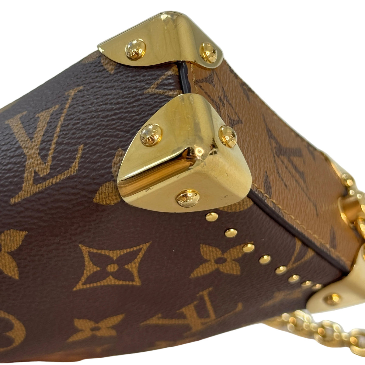 Louis Vuitton Slim Trunk Monogram Canvas Shoulder Crossbody Bag – Close-up of a Louis Vuitton monogram handbag corner with