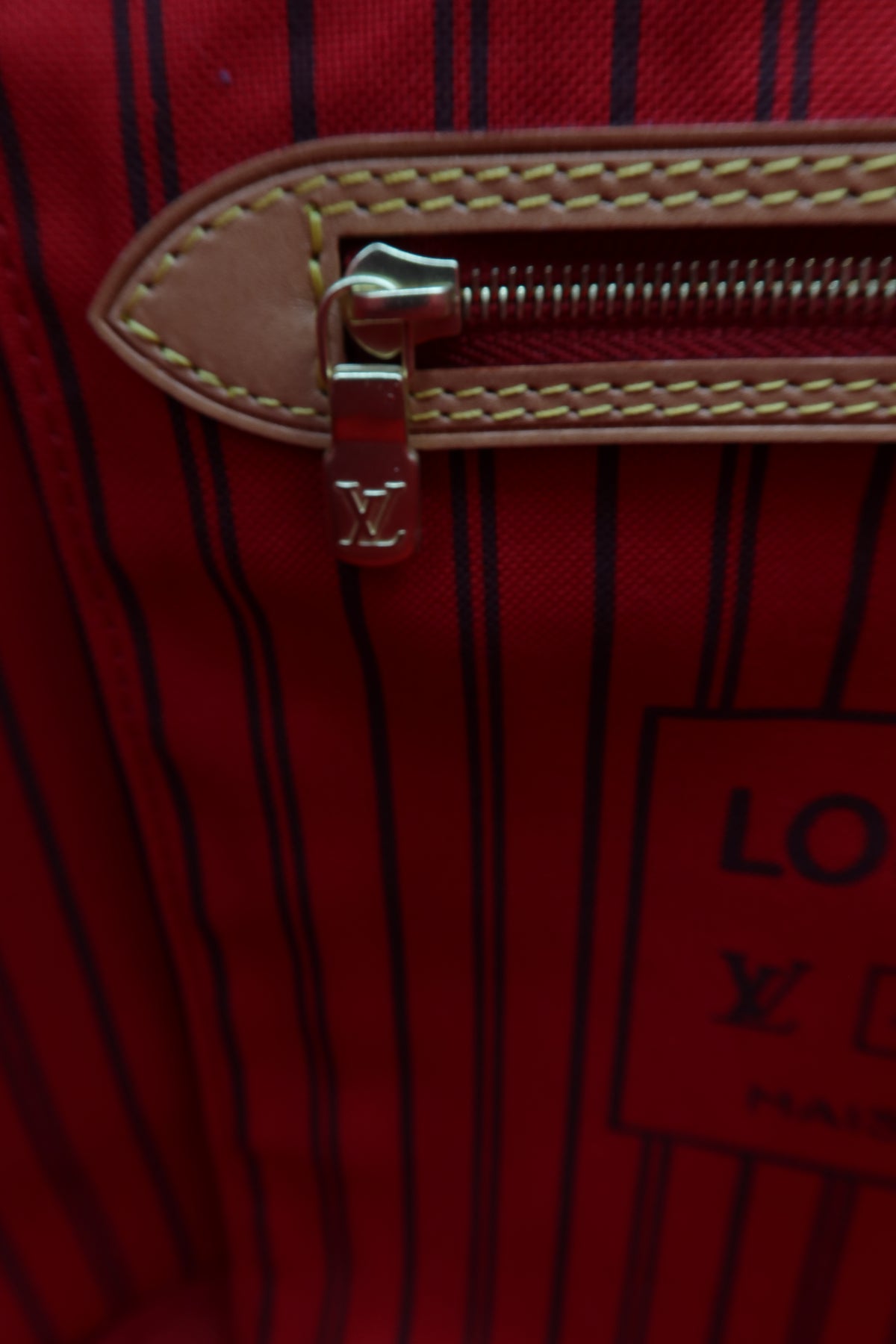 Pre-Owned Louis Vuitton Monogram Tote Bag – Brown – Close-up of a Louis Vuitton red striped bag interior showing a tan