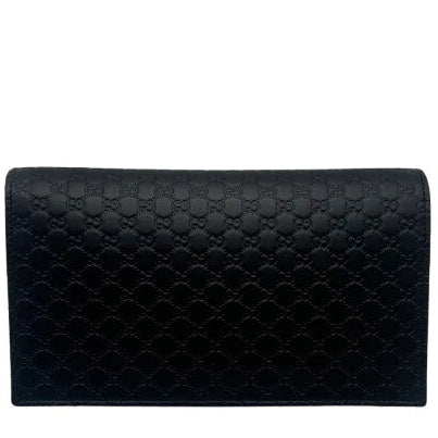 Black quilted clutch bag on a white background